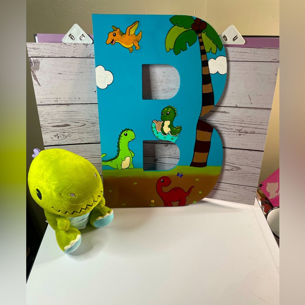 Hand painted Dino themed wooden letters B. Includes stuffed Dino plush.
